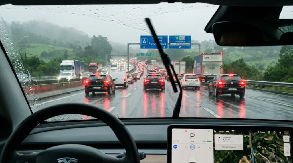 Driver's-eye view of a wet motorway in heavy rain and traffic